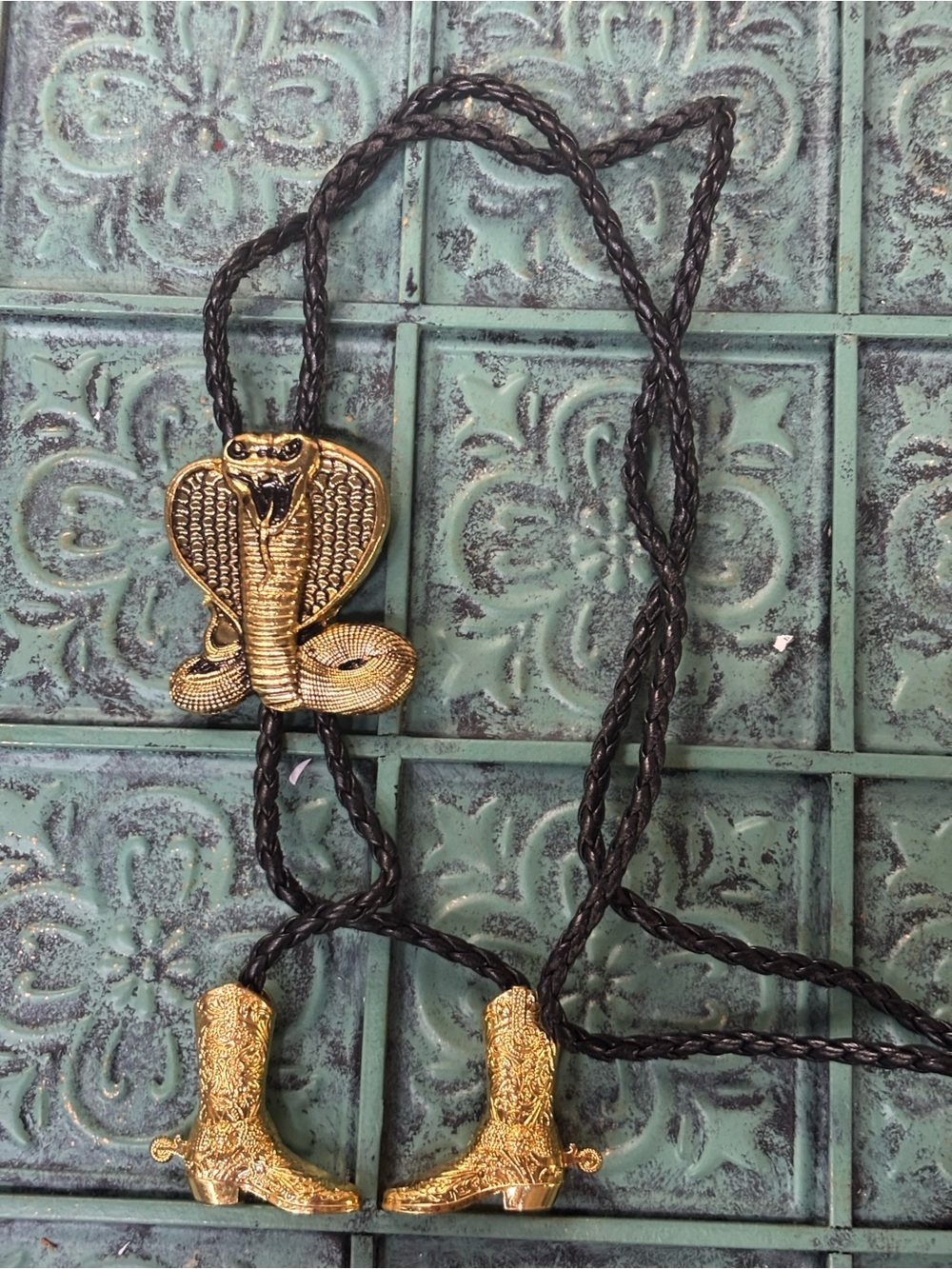New gold-tone cobra snake bolo tie featuring a detailed cobra slide